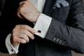 Man in suit hold his white shirt with cuff links. Royalty Free Stock Photo