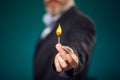 Man in suit holding burning match in hand Royalty Free Stock Photo