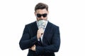 Man in suit holding cash money in dollar banknotes on isolated white background. Studio portrait of businessman with Royalty Free Stock Photo