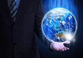 Man in suit holding a earth in hand Royalty Free Stock Photo