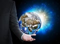 Man in suit holding a earth in hand Royalty Free Stock Photo