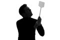 Man in suit holding a fly swatter wanting to kill annoying mosquito Royalty Free Stock Photo