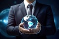 A man in a suit holding a globe in his hands. Business concept. Globalization of the economy and trade relations