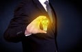 Man in suit holding a glowing yellow light bulb Royalty Free Stock Photo