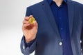 Macro Man in suit holding gold bitcoin coin isolated on white background. Copy space and mock up. Selective focus and business Royalty Free Stock Photo