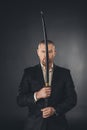 man in suit holding katana sword in front of his face Royalty Free Stock Photo
