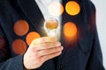 Man in suit holding light bulb with model of human brain. Electric power and new technology concept.