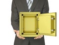 Man in a suit holding open gold safe