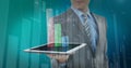 Man in suit holding tablet, displaying graphs, standing