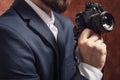 Man in suit holds old camera Royalty Free Stock Photo