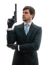 Man in suit holds pistol with silencer in hand. Isolated on white background