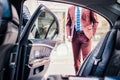 Man in suit with lap top standing near automobile