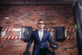 Man in suit lifting weight in gym Royalty Free Stock Photo