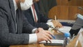 A man in a suit - a politician, official or a businessman with a fountain pen corrects the text of the document, sitting at the Royalty Free Stock Photo