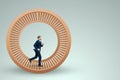 A man in a suit runs in a hamster wheel. The concept of liberation from slavery, life, business, manipulation, control Royalty Free Stock Photo