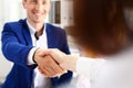 Man in suit shake hand as hello in office closeup