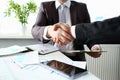 Man in suit shake hand as hello in office