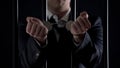 Man In Suit Showing Hands In Handcuffs Behind Bars, Bribery, Financial Fraud