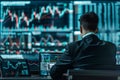 A man in a suit sits in front of a computer monitor, analyzes data on his computer screen