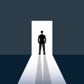 Man in suit standing in opened door towards light Royalty Free Stock Photo