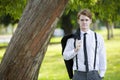 Man in suit standing in park Royalty Free Stock Photo