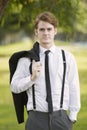 Man in suit standing in park Royalty Free Stock Photo