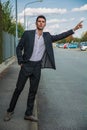 Photo of a businessman talking on a phone hailing a taxi cab Royalty Free Stock Photo