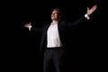 man in suit talking giving motivation training from speaker stage, raising hands