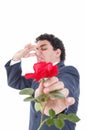 Man in suit throws a rose and gives it to the camera with face Royalty Free Stock Photo