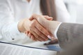 Man in suit and tie give hand as hello in office