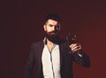 Man in suit toasting with sparkling glass of red wine