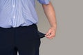 Man in suit turning pocket of his trousers inside out and showing it empty Royalty Free Stock Photo