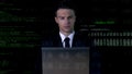 Man in suit typing on laptop, software code on background, password hack