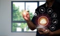 A man in a suit uses his left hand to hold the cloud computing symbol in his hand and the business symbol is placed around it