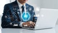 Businessman using a laptop with an AI driven data network interface. Royalty Free Stock Photo
