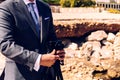 Man in a suit using a compact photo camera on a tripod to take a self-portrait to use as a profile in his business and social Royalty Free Stock Photo