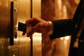 Man in a suit using a key card to access a secured door in a hotel corridor Royalty Free Stock Photo
