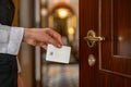Man in a suit using a key card to access a secured door in a hotel corridor Royalty Free Stock Photo