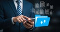 Man in suit using smartphone with digital files and blue folder icon mobile phone technology Royalty Free Stock Photo