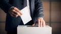 Man in a suit voting, putting paper in a ballot box, concept of politics and elections. Royalty Free Stock Photo