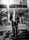 Man in suit walking down the stairs at business building Royalty Free Stock Photo