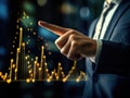 Man in suit, wearing tie and holding his finger up, is standing next to an illuminated graph. The lighted graph shows