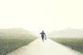 Man with suitcase runs fast on a deserted road to an unknown destination