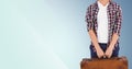 Man with suitcase standing against blue background Royalty Free Stock Photo