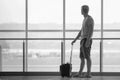 Man with suitcase waiting a plane at terminal airport Royalty Free Stock Photo