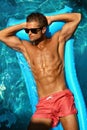 Man Summer Fashion. Male Model Tanning By Pool. Skin Tan Royalty Free Stock Photo