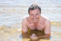 Man in summer vaction lying on sand water holidays Royalty Free Stock Photo