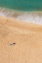 Man sun bathing solo on secluded beach Royalty Free Stock Photo