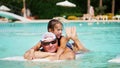 man in sun glasses, father and daughter, kid girl, playing in the pool water, having fun together. Happy family relaxing Royalty Free Stock Photo