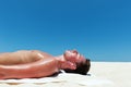 Man sunbathes and listens to music on the beautiful beach Royalty Free Stock Photo